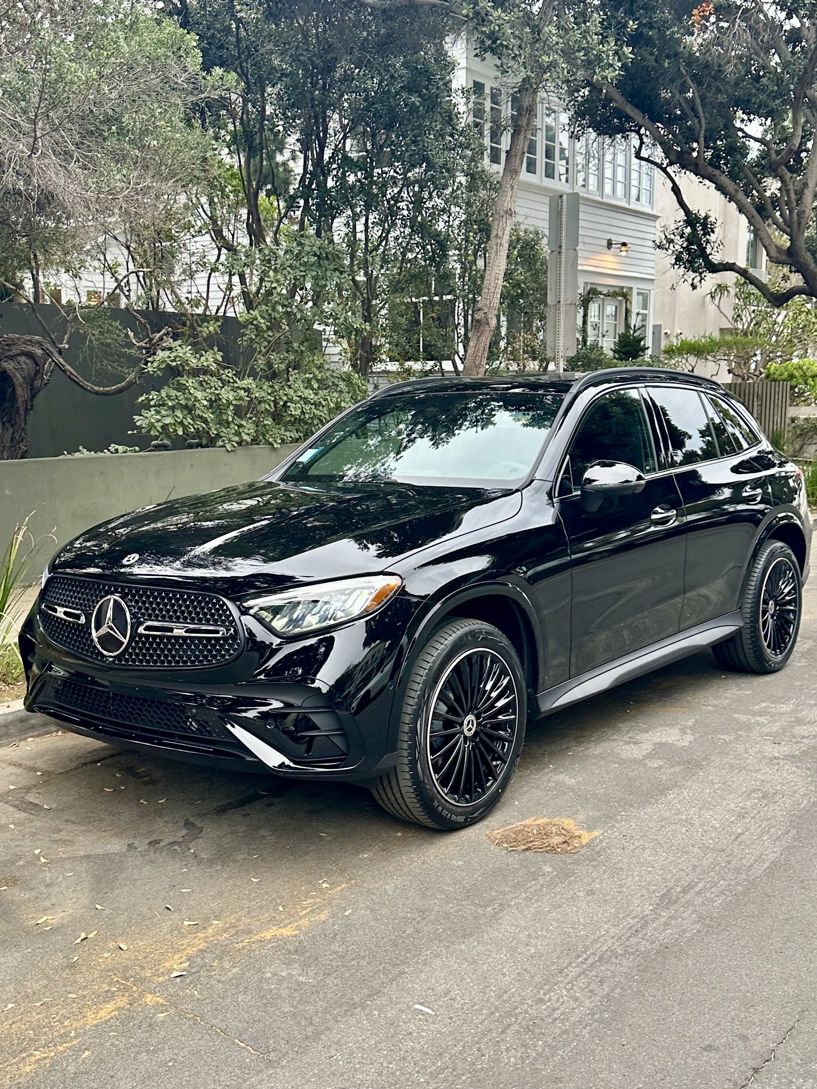 Freshly detailed black Mercedes-Benz GLC SUV parked on a residential street